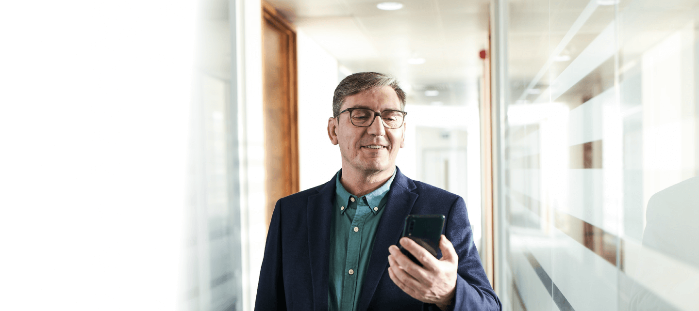 A man holding and watching his cellphone