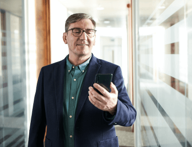 A man holding and watching his cellphone